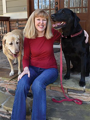 Sandy Altman sitting with her dogs