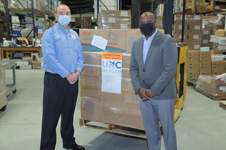 Tom Williams, Johnston Health CEO and Dr. Eric Bracy, Johnston County Public Schools Superintendent stand with mask donation