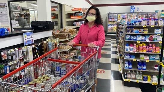 Barbara shops for canned food.