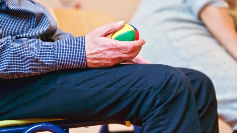 Adult holding exercise ball.