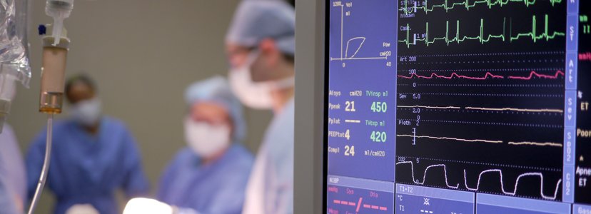 monitor with surgeons in background