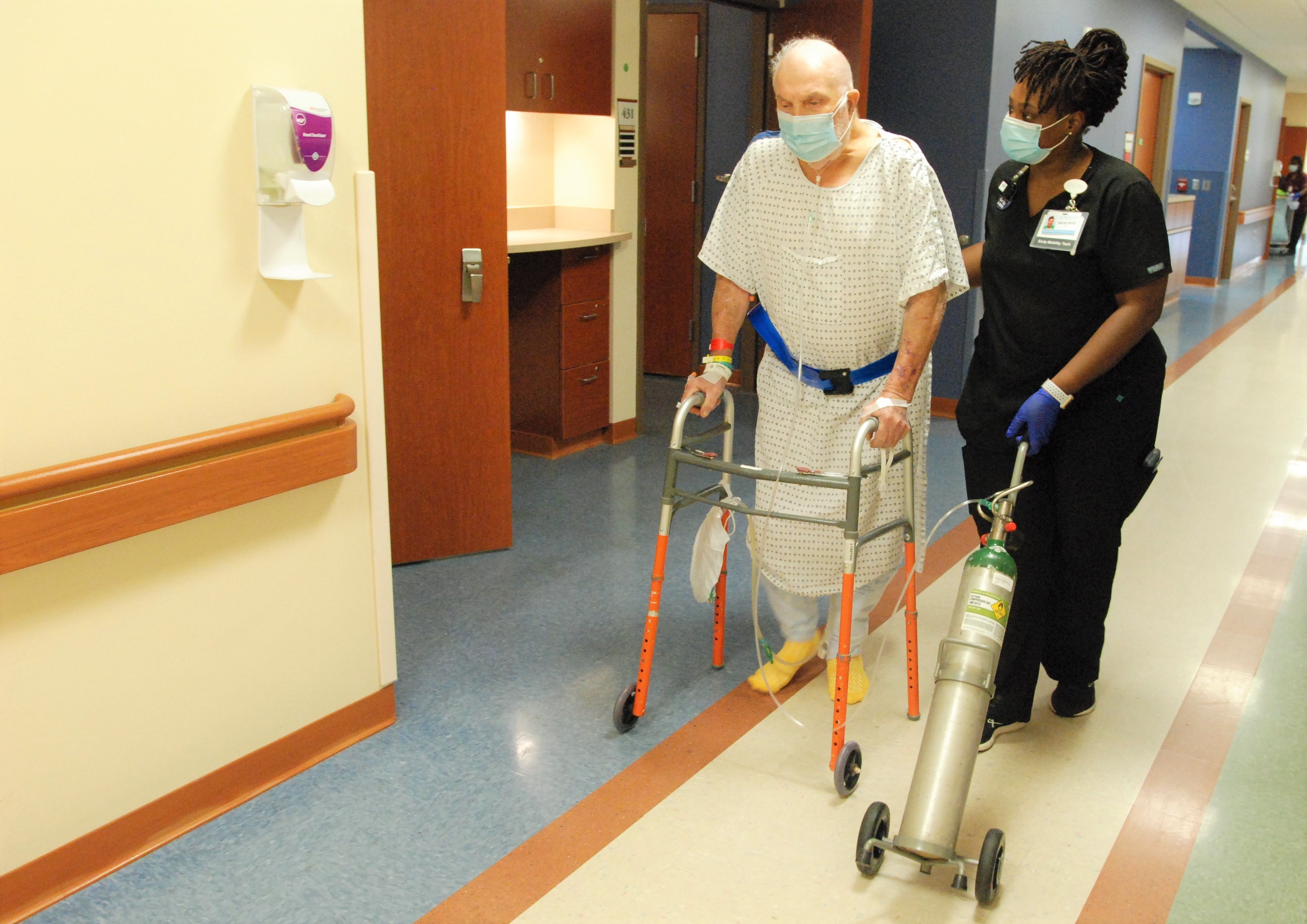 nurse and patient walking down hall